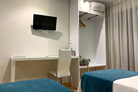 two white and blue beds of verona hostel