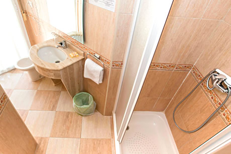 bathroom, hairdryer and shower in hotel albero