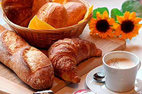 table with breakfast, orange juice in hotel albero