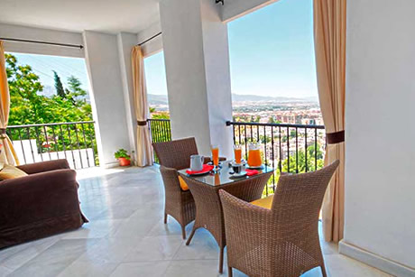 two chairs with a table on the terrace at the arabeluj hotel