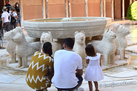 family next to lions fountain
