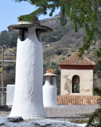 chimnney and chrurch in background in alpujarra village