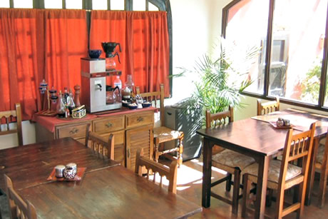 cafee shop in hostel california with wooden tables and cahirs