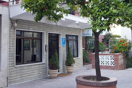entrance tothe building of hostel rocamar with tree in front