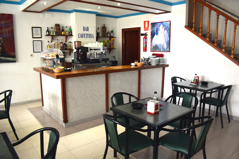 cafee shop with tables and chairs in hostel velilla