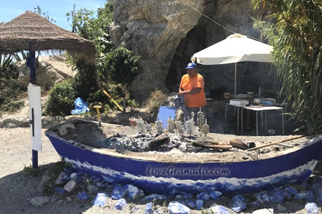 boat with grilled sardines in tesorillo beach in almuñecar