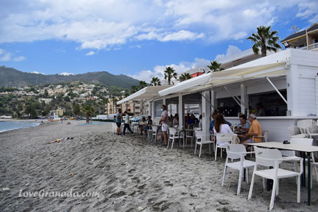views of the sea from amarre beach and a plate of black rice at the foot of the beach