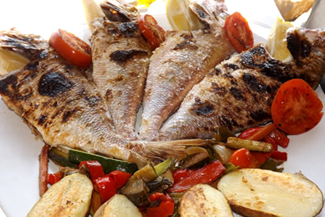 a plate of grilled fish in restaurant peñon in salobreña