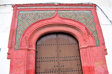 beautiful red door entrance to the church virgen del rosario