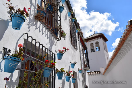 a street in the albacin neighborhood with lac pots hanging on the wall
