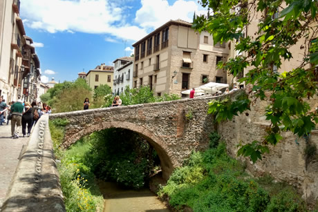 stone bridge in the carrera del darro, one of the essentials of granada