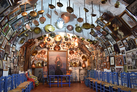 a cave decorated with utensils for flamenco shows in granada