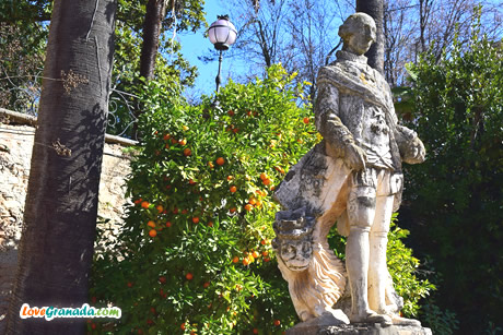 stone statue and oranges behind