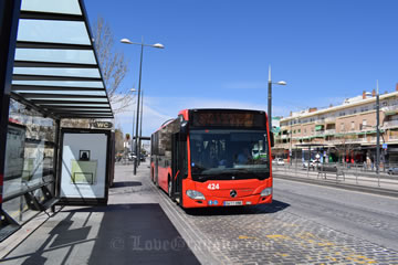 parked taxi and bus in front of bus station
