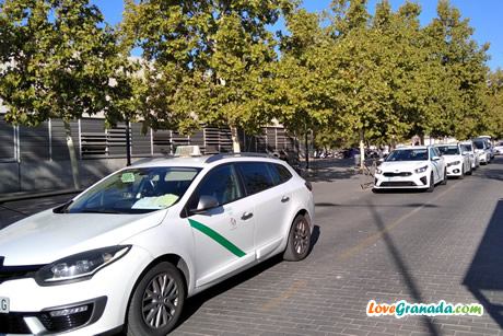 taxis and bus in front of granada bus station