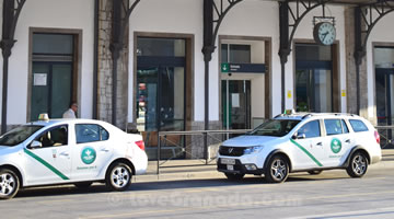 several taxis at the entrance to the train station
